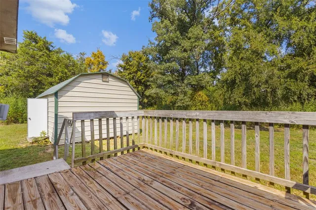 a view of a wooden deck with a yard