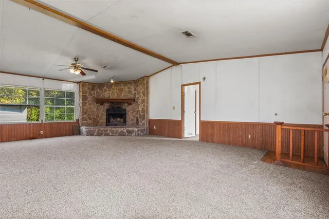 a view of an empty room with a fireplace