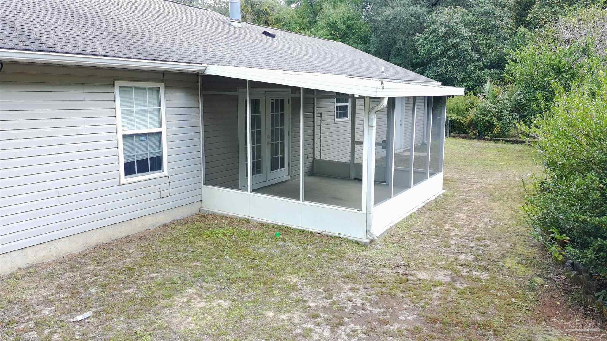6333 Rice Street Milton, FL 32583 - Photo 17 of 19 a view of a house with a yard and balcony