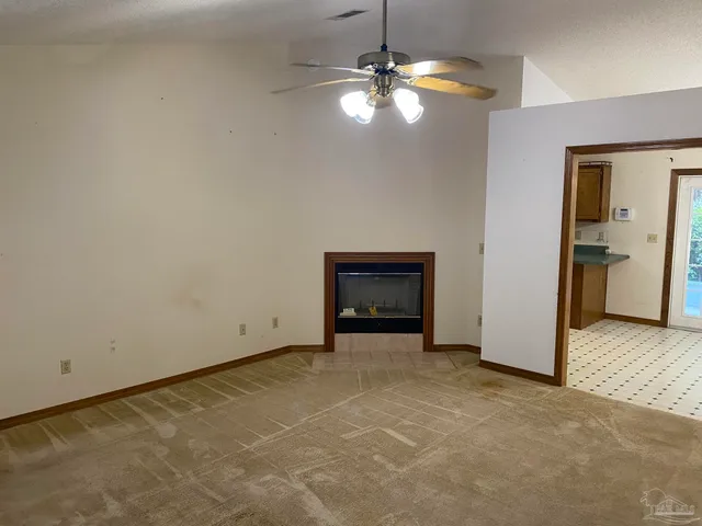a view of an empty room with a fireplace
