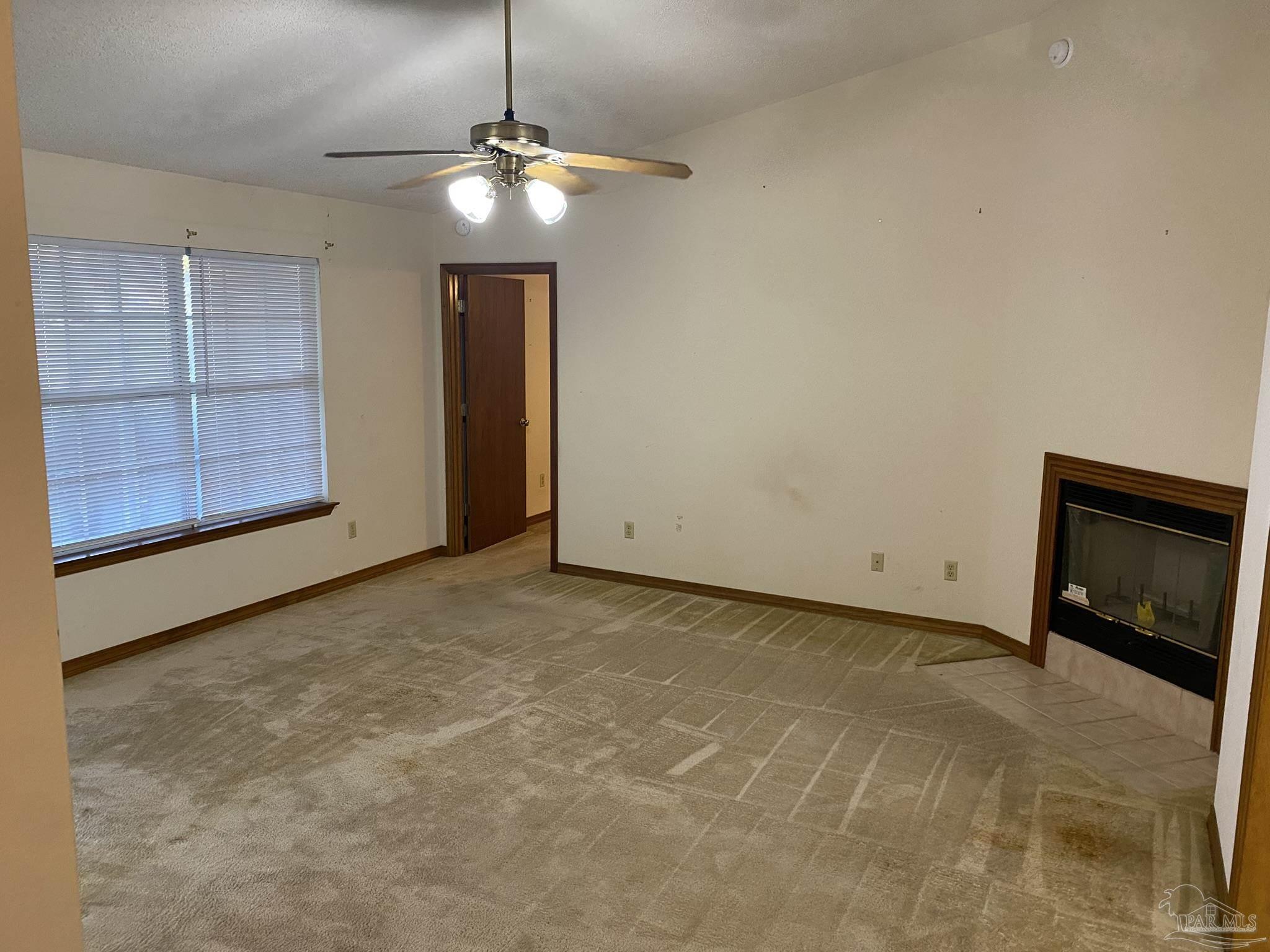 6333 Rice Street Milton, FL 32583 - Photo 5 of 19 a view of an empty room with a fireplace and cabinet