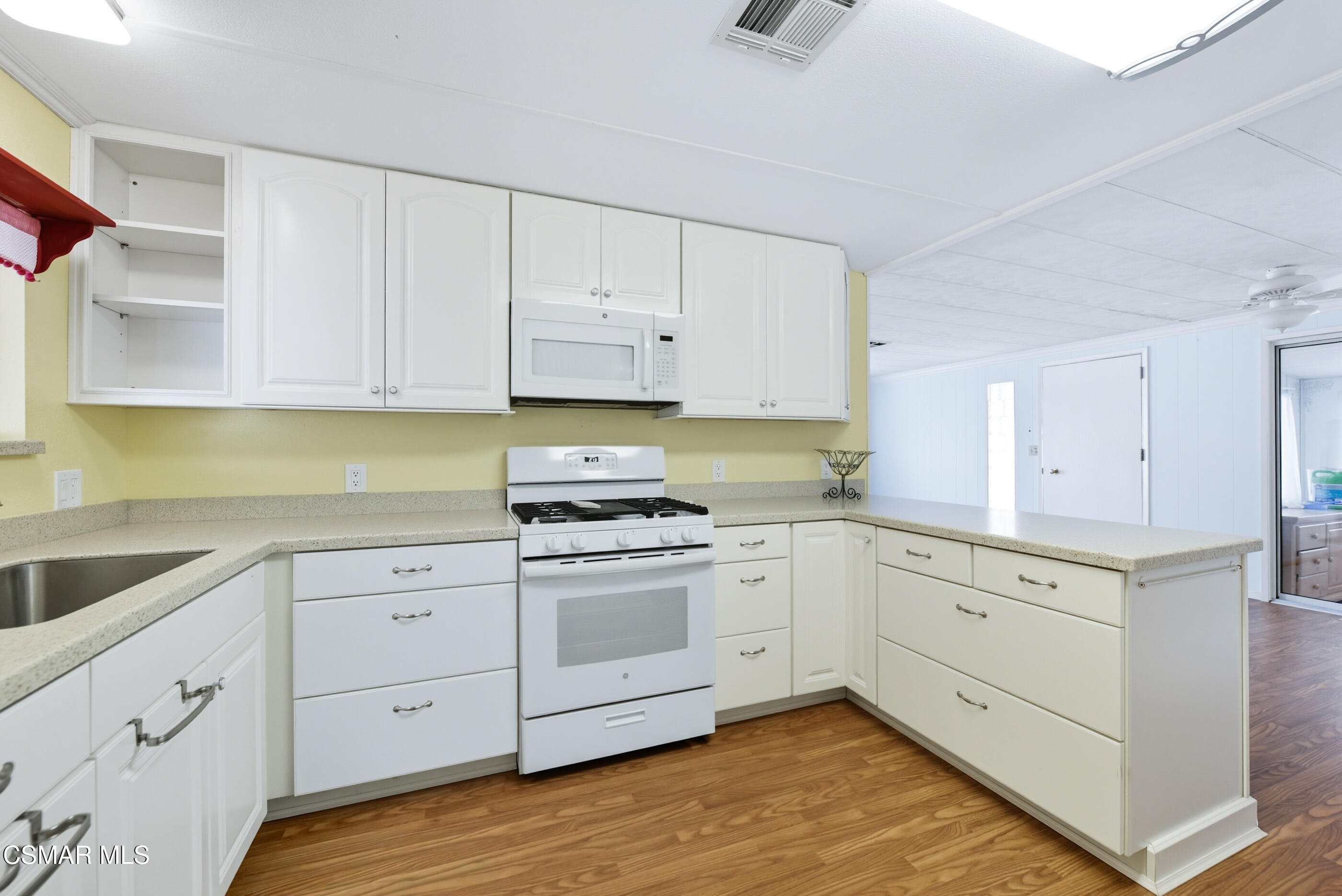 195 Tierra Rejada Road, Unit 178 Simi Valley, CA 93065 - Photo 14 of 49 a kitchen with cabinets appliances and a sink