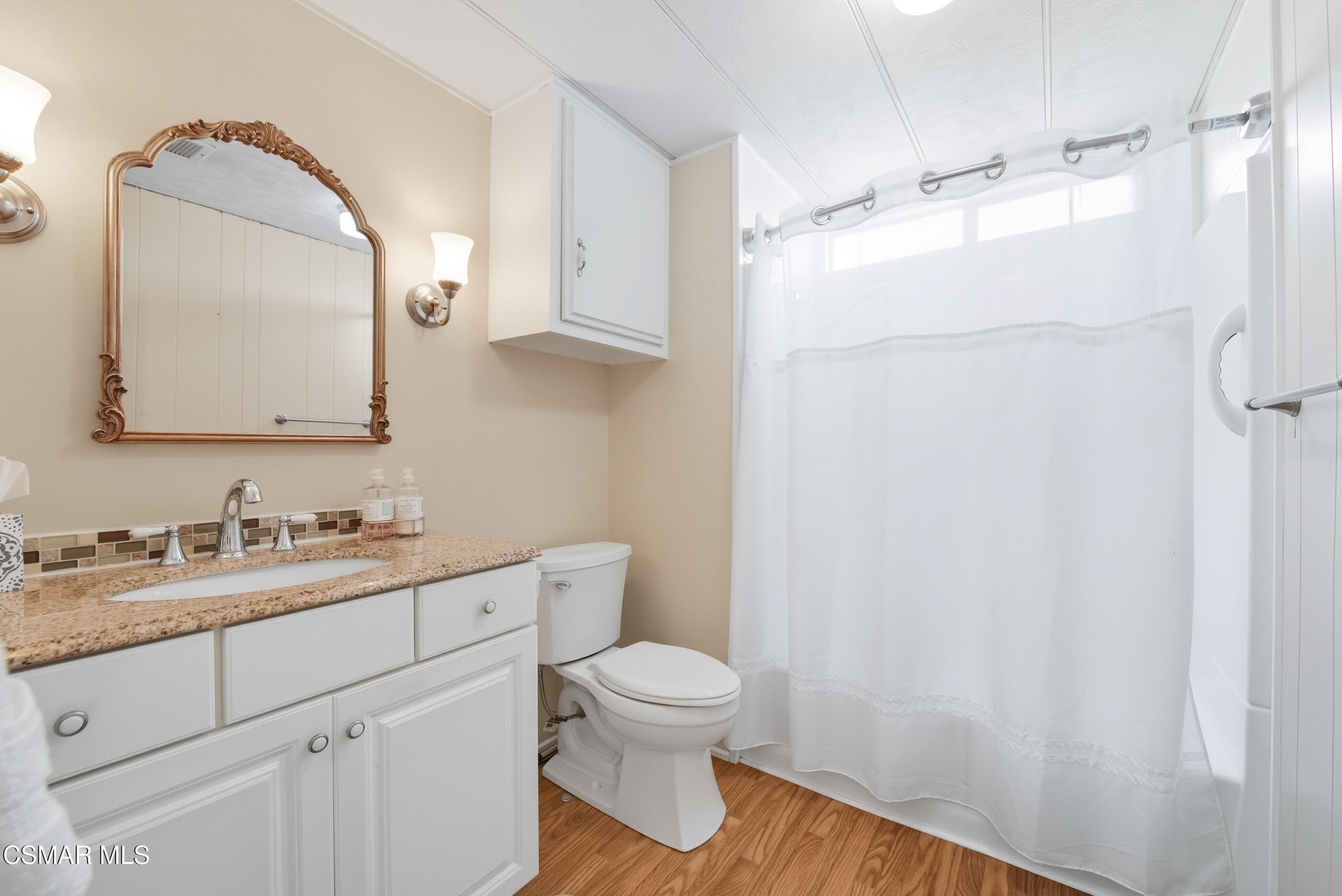 195 Tierra Rejada Road, Unit 178 Simi Valley, CA 93065 - Photo 17 of 49 a bathroom with a granite countertop sink toilet a mirror and shower
