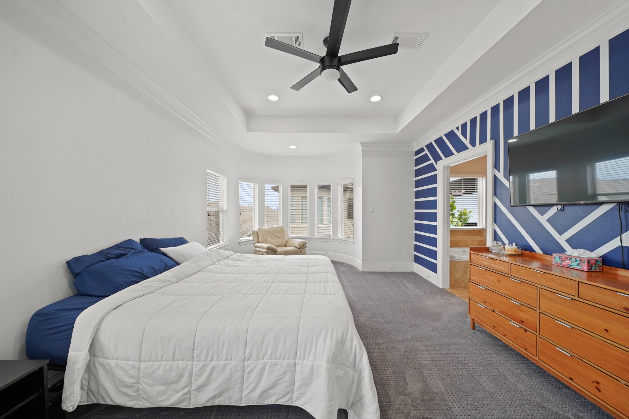 3808 Center Street, Unit A Houston, TX 77007 - Photo 16 of 31 a bed room with a bed and a ceiling fan
