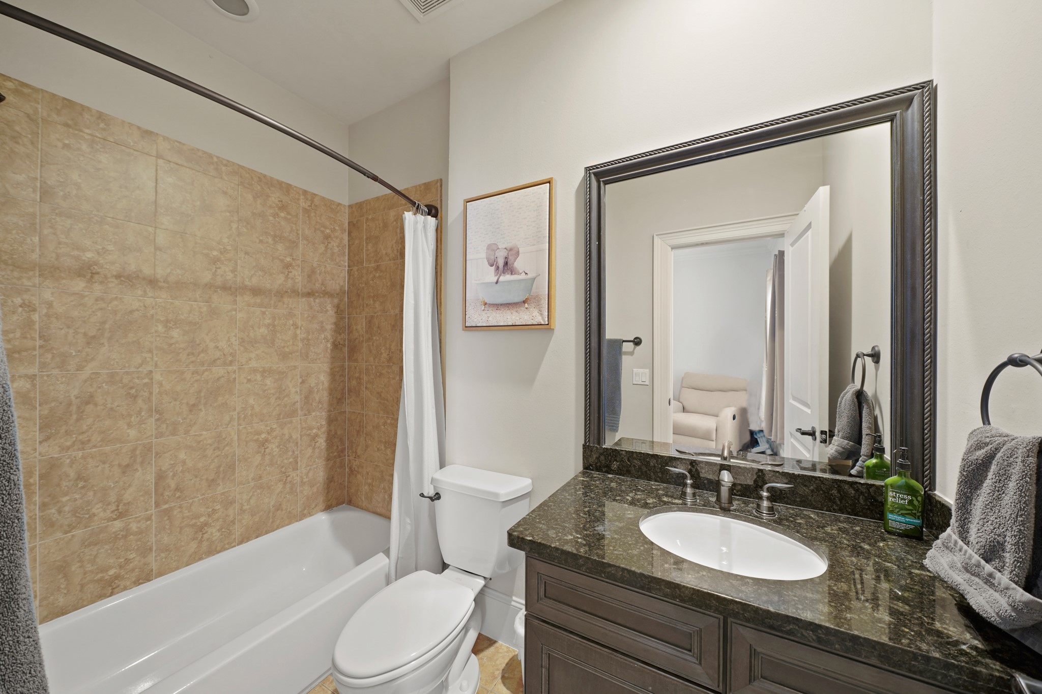 3808 Center Street, Unit A Houston, TX 77007 - Photo 25 of 31 a bathroom with a granite countertop sink toilet a mirror a bathtub and shower