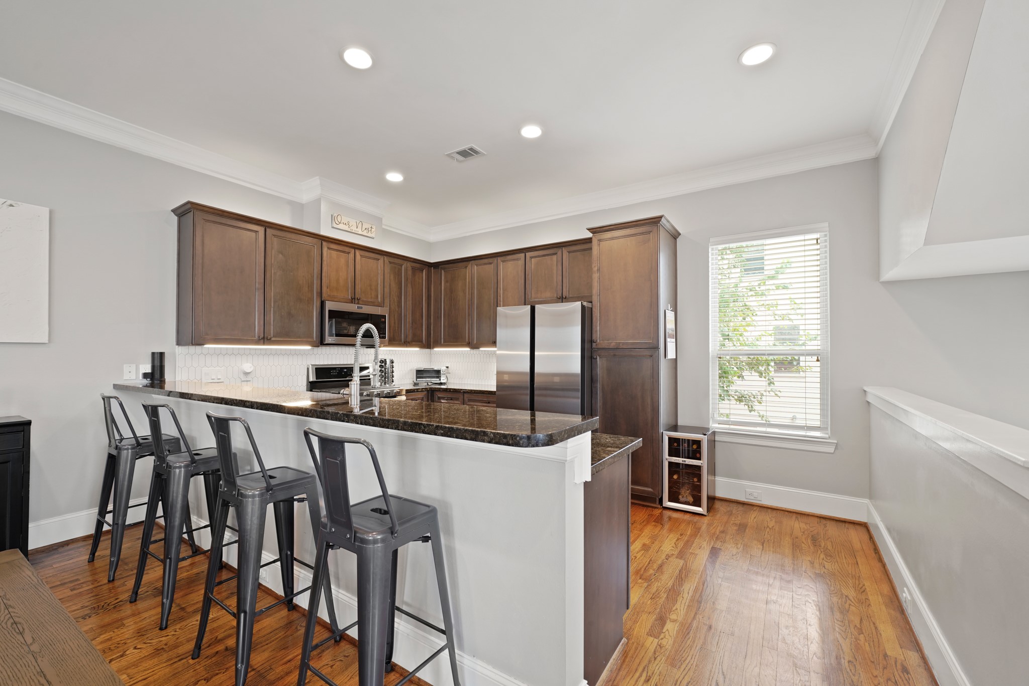 3808 Center Street, Unit A Houston, TX 77007 - Photo 5 of 31 a kitchen with stainless steel appliances a table chairs refrigerator and microwave