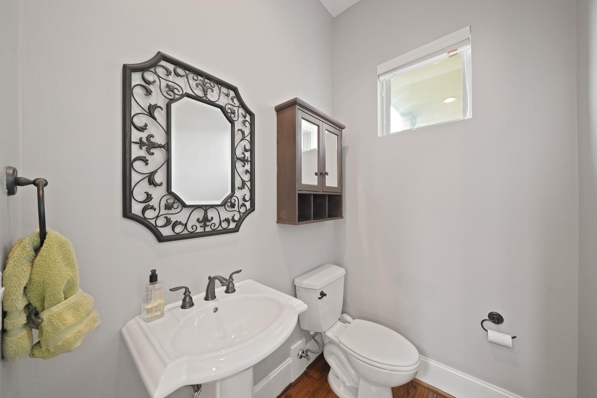 3808 Center Street, Unit A Houston, TX 77007 - Photo 9 of 31 a bathroom with a toilet sink and mirror