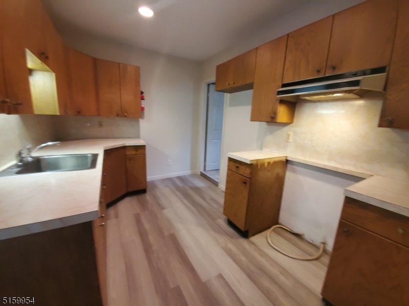 2 Main Street, Unit 1 Branchville, NJ 07826 - Photo 10 of 11 a kitchen with wooden cabinets and a sink