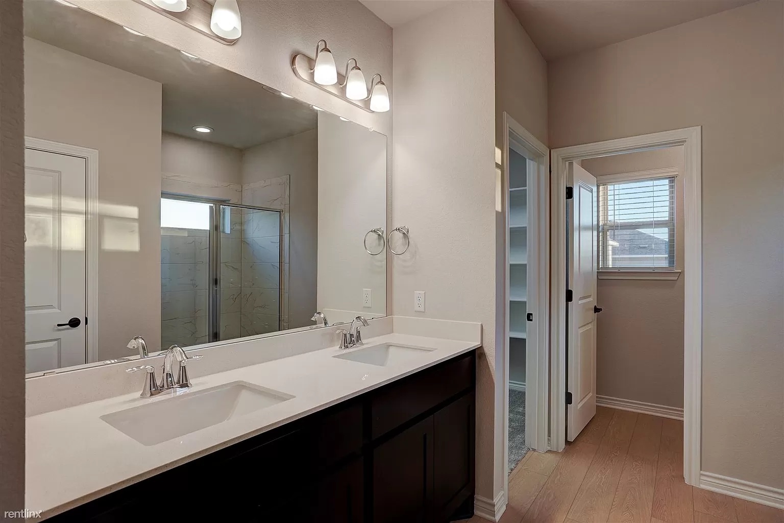 1809 Turtle Bay Loop Leander, TX 78641 - Photo 13 of 30 a bathroom with a double vanity sink a mirror and a shower