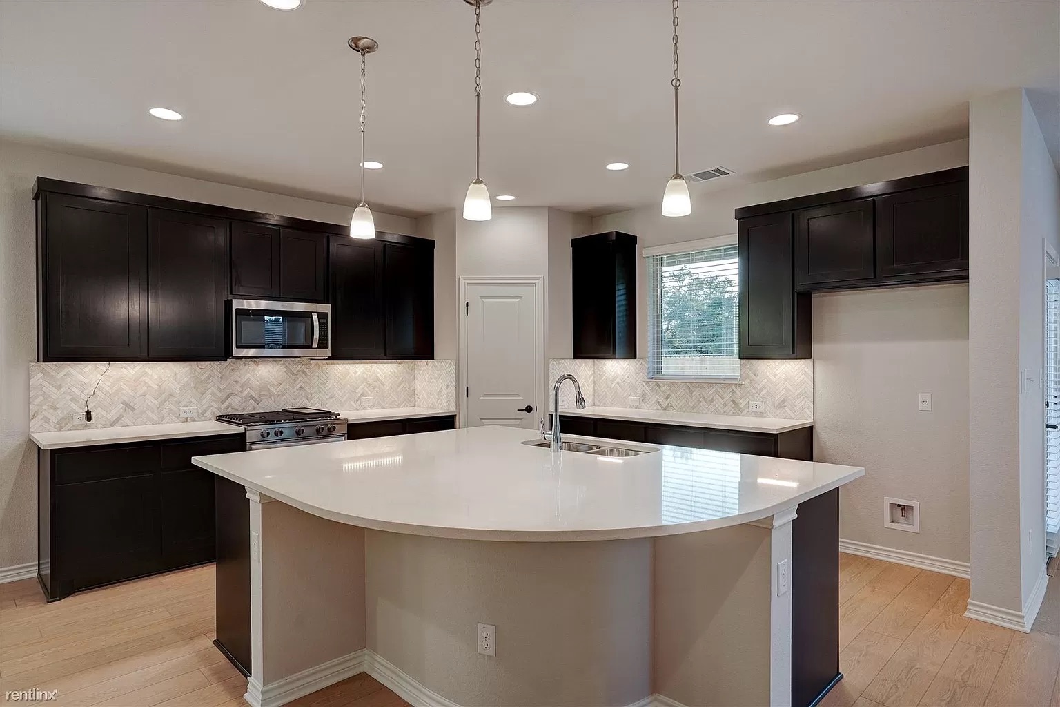 1809 Turtle Bay Loop Leander, TX 78641 - Photo 5 of 30 a kitchen with stainless steel appliances granite countertop a sink a stove and a refrigerator