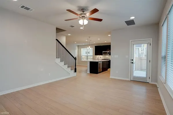 a view of kitchen with stove and microwave