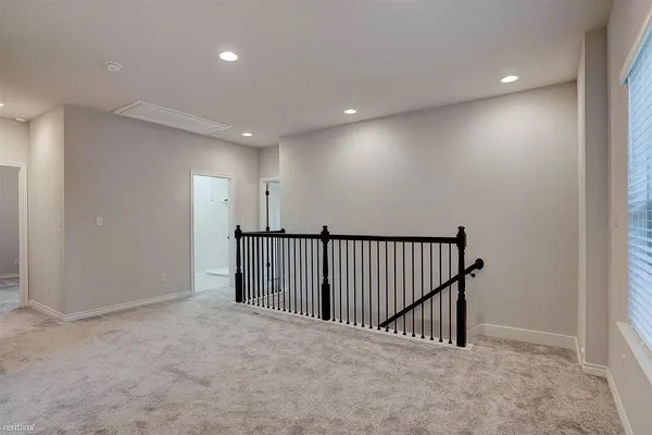 an empty room with closet and windows