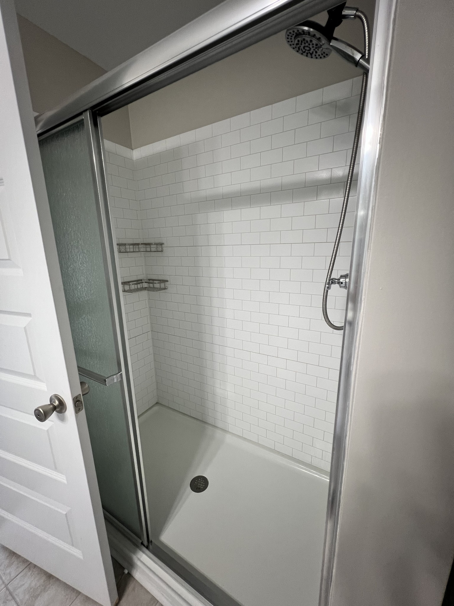 1056 Wells Way Spring Hill, TN 37174 - Photo 11 of 11 a bathroom with a glass shower door