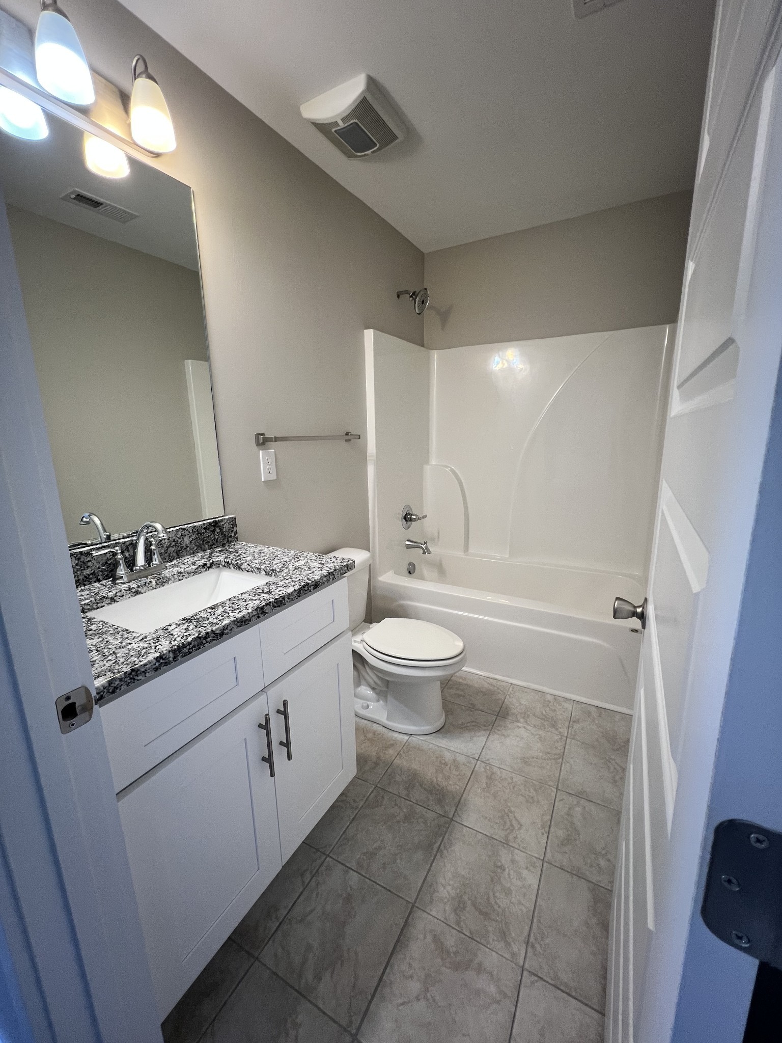 1056 Wells Way Spring Hill, TN 37174 - Photo 7 of 11 a bathroom with a granite countertop sink toilet and shower