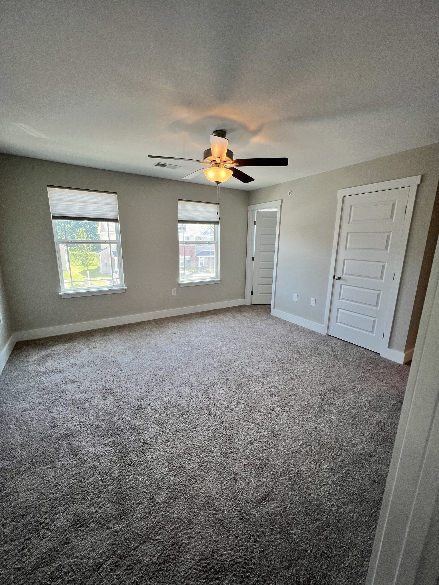 1056 Wells Way Spring Hill, TN 37174 - Photo 9 of 11 en empty room with windows and ceiling fan