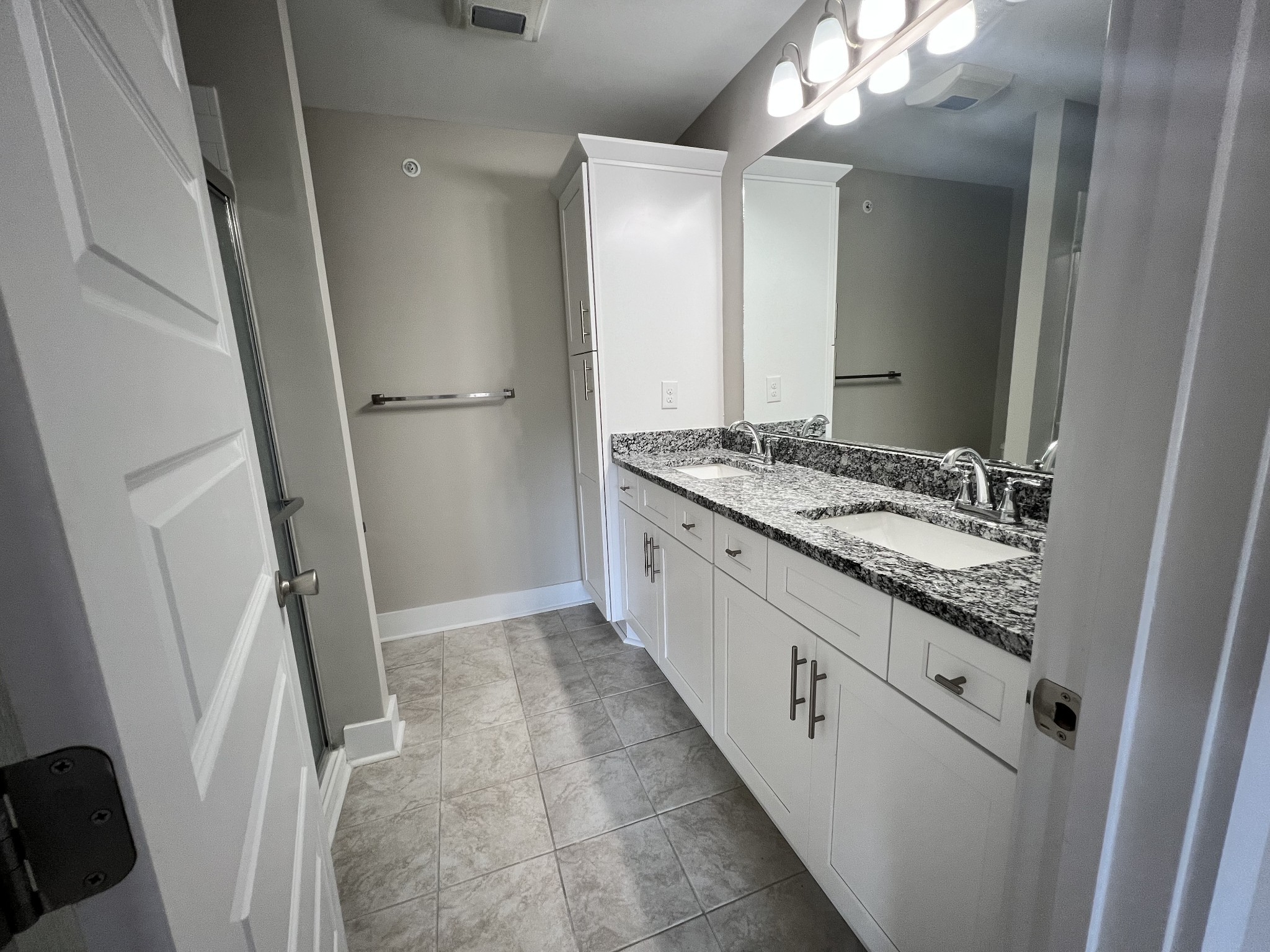 1056 Wells Way Spring Hill, TN 37174 - Photo 10 of 11 a bathroom with a granite countertop sink a mirror and a shower
