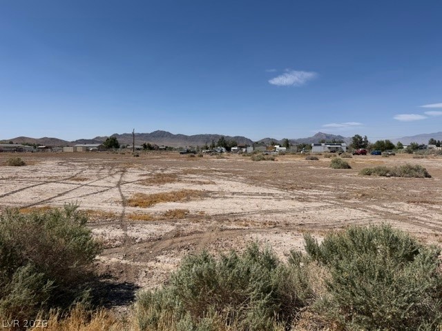 4580 Flamingo Road Pahrump, NV 89048 - Photo 2 of 3 A vast, undeveloped land parcel with distant mountains, offering potential for various ventures.