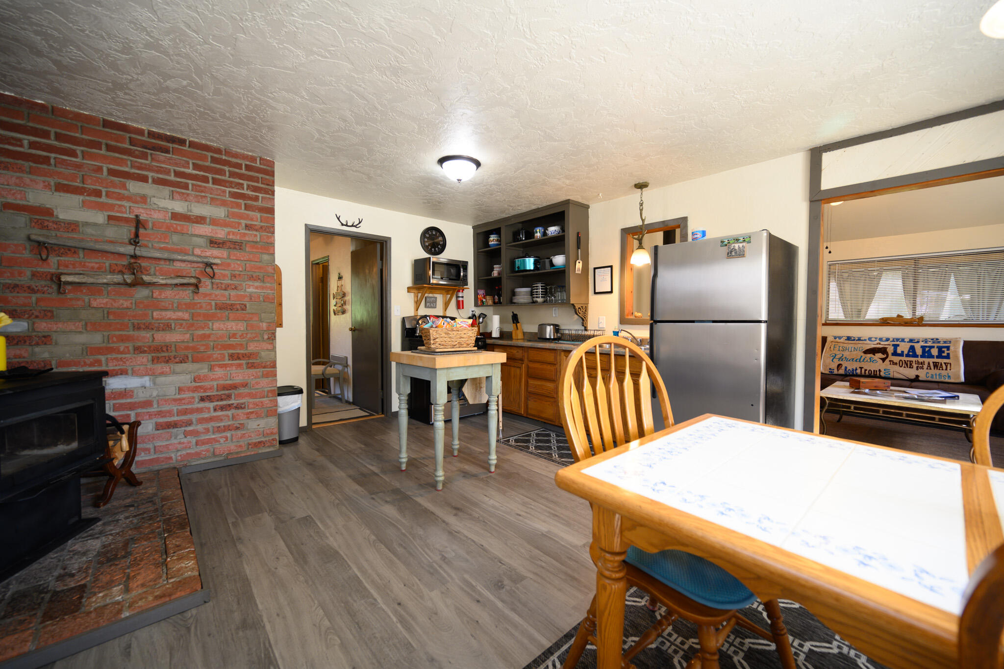 2951 Lewiston Road Lewiston, CA 96052 - Photo 13 of 27 a kitchen with stainless steel appliances wooden floor dining table and chairs