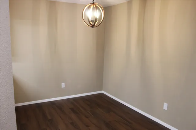 a view of a small space with wooden floor and a window