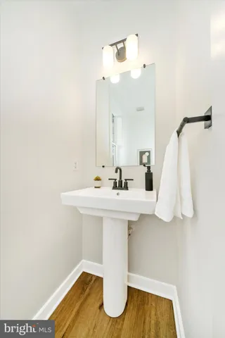 a bathroom with a sink a mirror and vanity