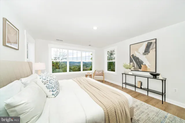 a bedroom with a bed and a painting on the wall