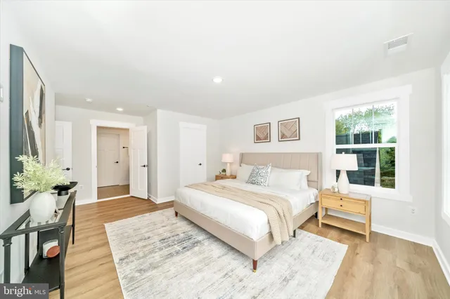 a bedroom with a large bed and a couch