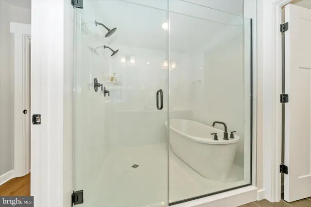 a bathroom with a tub a sink and shower