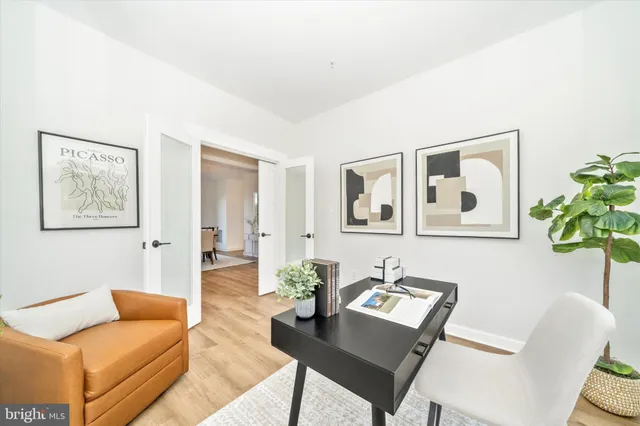 a living room with furniture and a potted plant