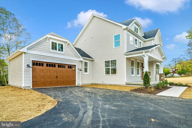 a front view of a house with a garden and entryway