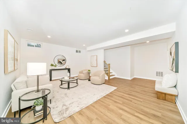 a bedroom with furniture and a wooden floor