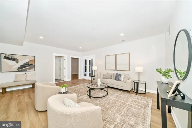 a living room with furniture and wooden floor