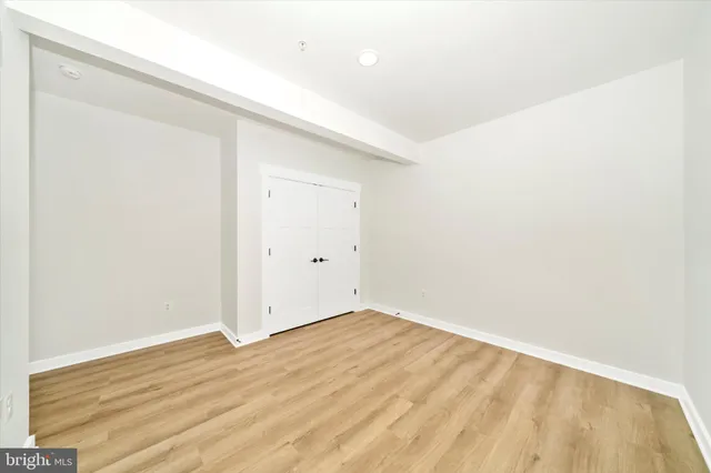 an empty room with wooden floor