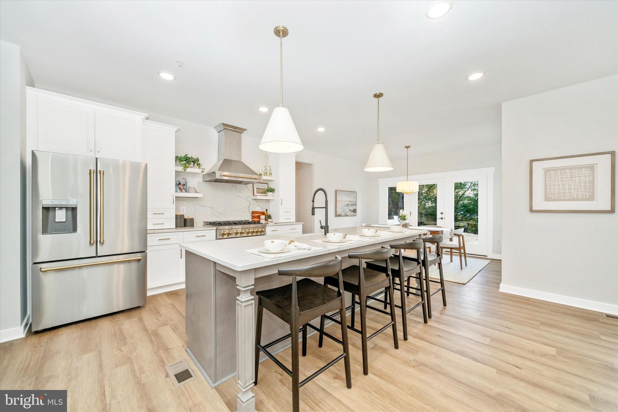 Old Bachmans Valley Road Westminster, MD 21157 - Photo 7 of 49 a kitchen with stainless steel appliances kitchen island granite countertop a table chairs stove and refrigerator