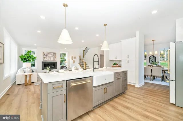 a large white kitchen with lots of counter space and appliances