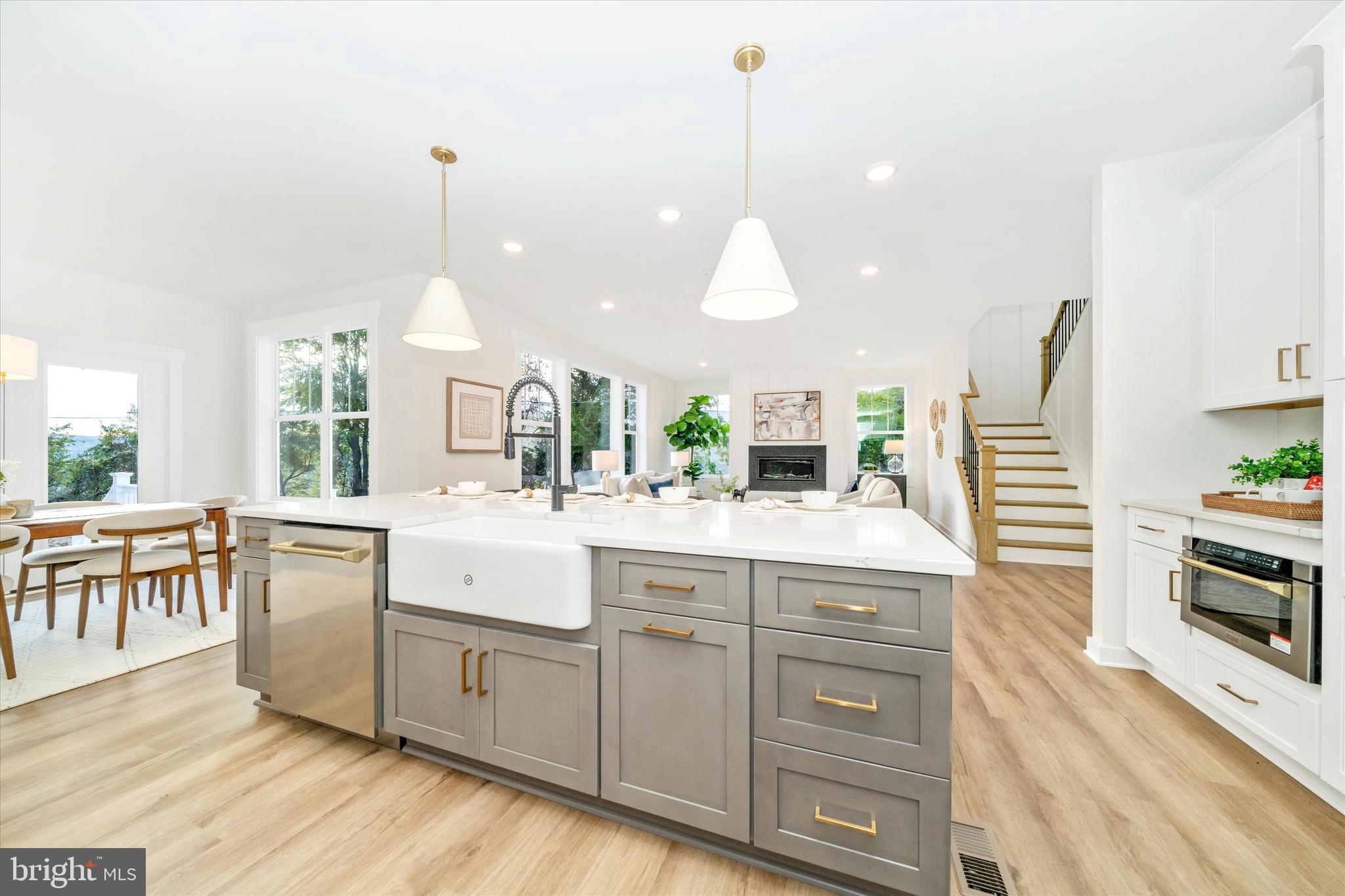 Old Bachmans Valley Road Westminster, MD 21157 - Photo 10 of 49 a large kitchen with kitchen island granite countertop a stove a sink a dining table and chairs with wooden floor
