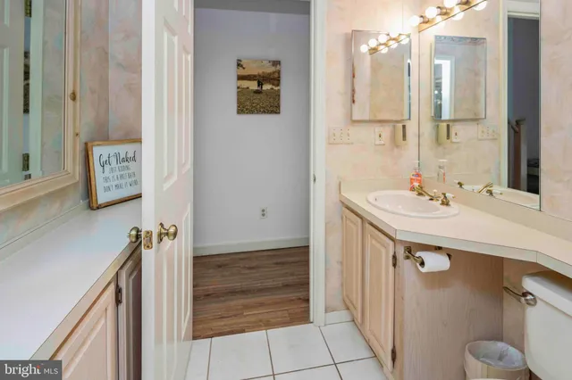 a bathroom with a tub sink and mirror