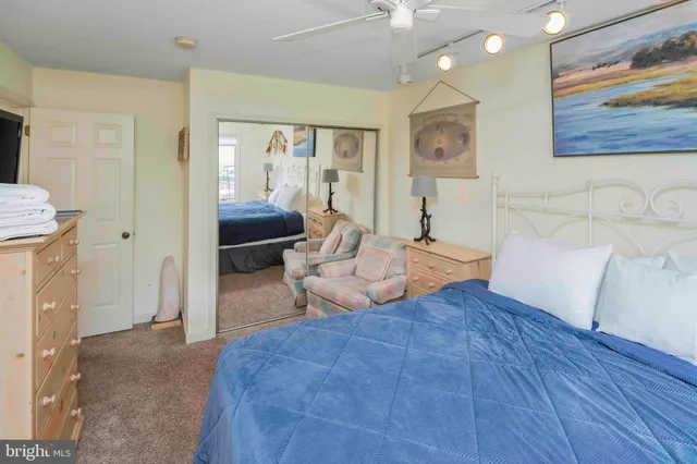 a bedroom with a bed dresser and window