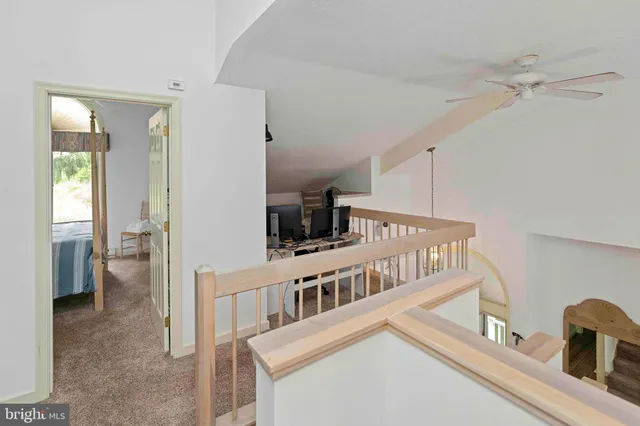 a bedroom with two beds and painting on the wall