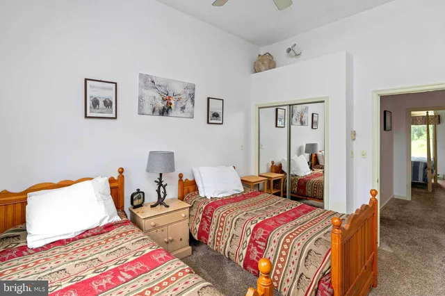 a bedroom with a bed and a view of bathroom