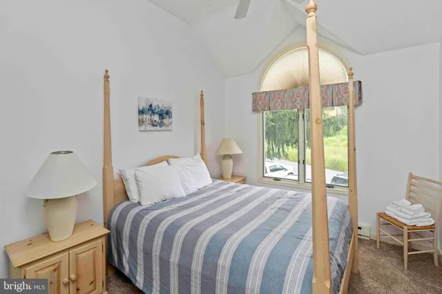 a bathroom with a granite countertop toilet sink and mirror