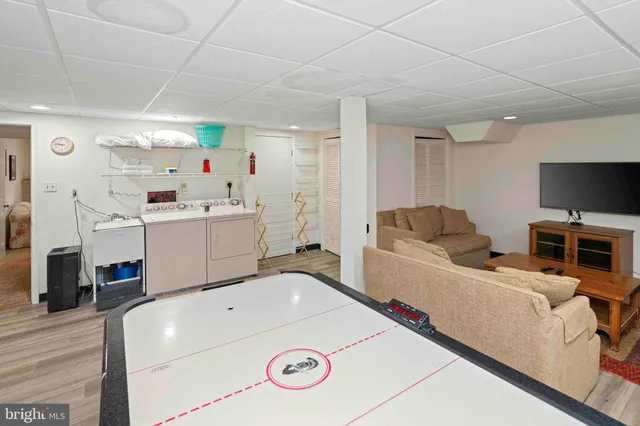 a bathroom with a sink a toilet a mirror and shower curtain