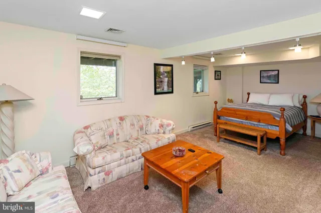 a bedroom with a bed and a couch