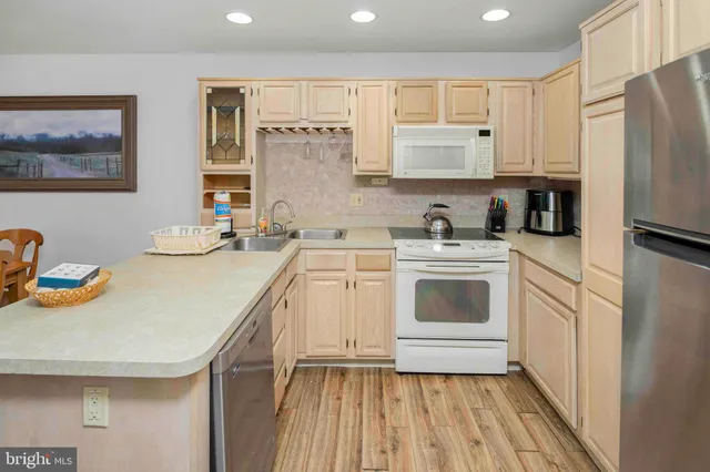 a kitchen that has a table chairs and a refrigerator