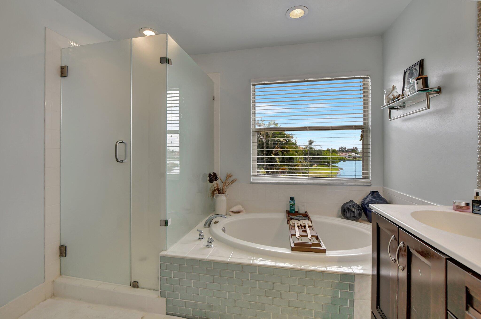 18498 East Covington Trace Boca Raton, FL 33498 - Photo 25 of 62 a bathroom with a tub a sink and a window