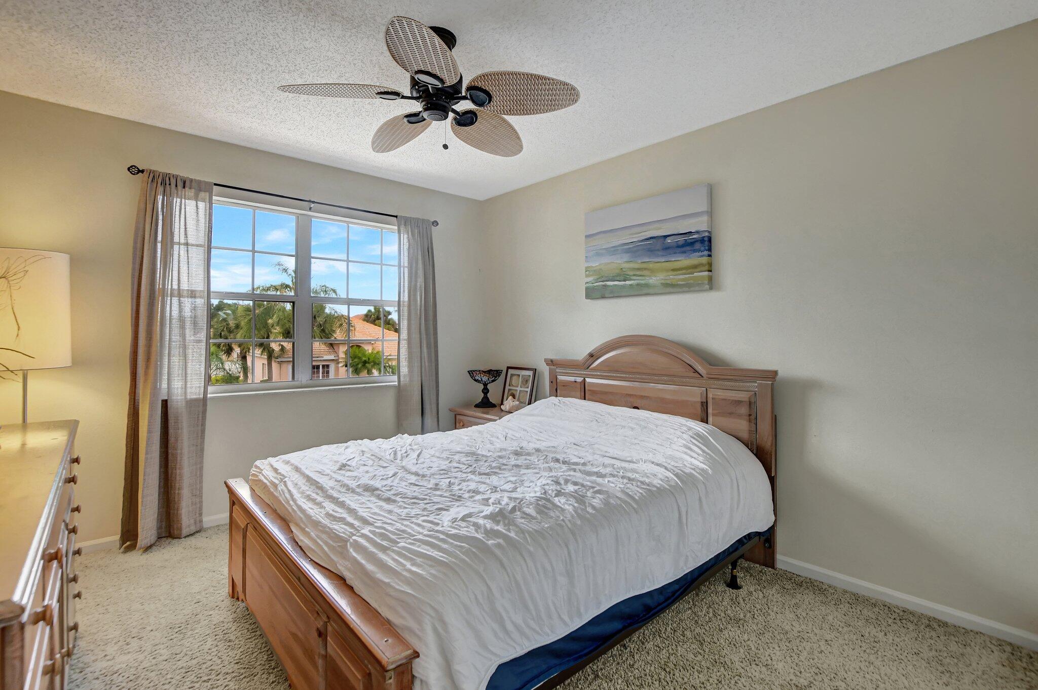 18498 East Covington Trace Boca Raton, FL 33498 - Photo 29 of 62 a bedroom with a bed and a painting on the wall