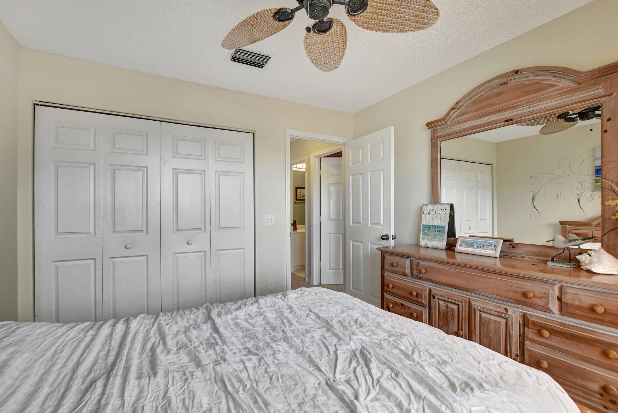 18498 East Covington Trace Boca Raton, FL 33498 - Photo 30 of 62 a bedroom with a bed and a chandelier