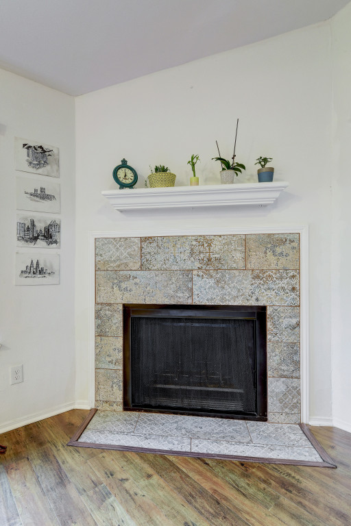 6002 Baton Rouge Drive Austin, TX 78727 - Photo 7 of 20 Fireplace featuring decorative tile surround, a dark metal firebox, and a white mantelpiece