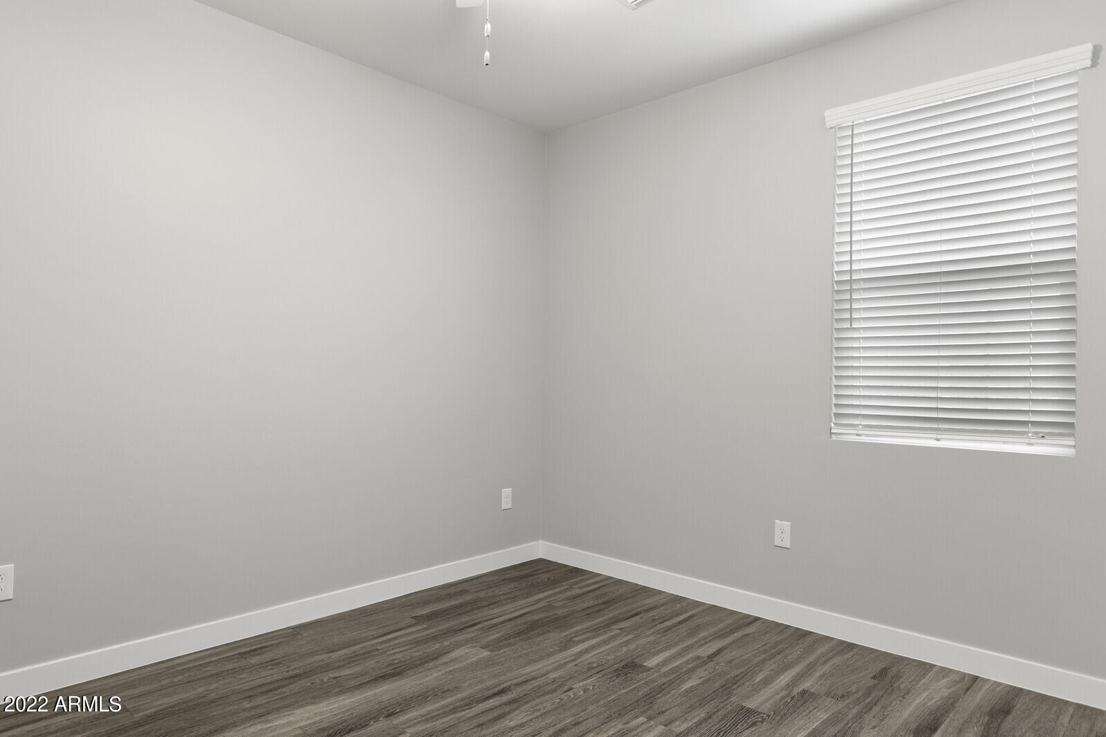 2245 North Dayton Street, Unit 4 Phoenix, AZ 85006 - Photo 23 of 28 a view of an empty room with wooden floor and a window