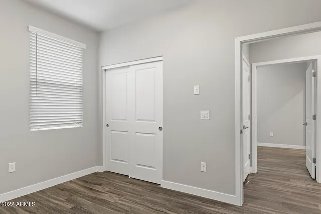 a view of room with window and wooden floor