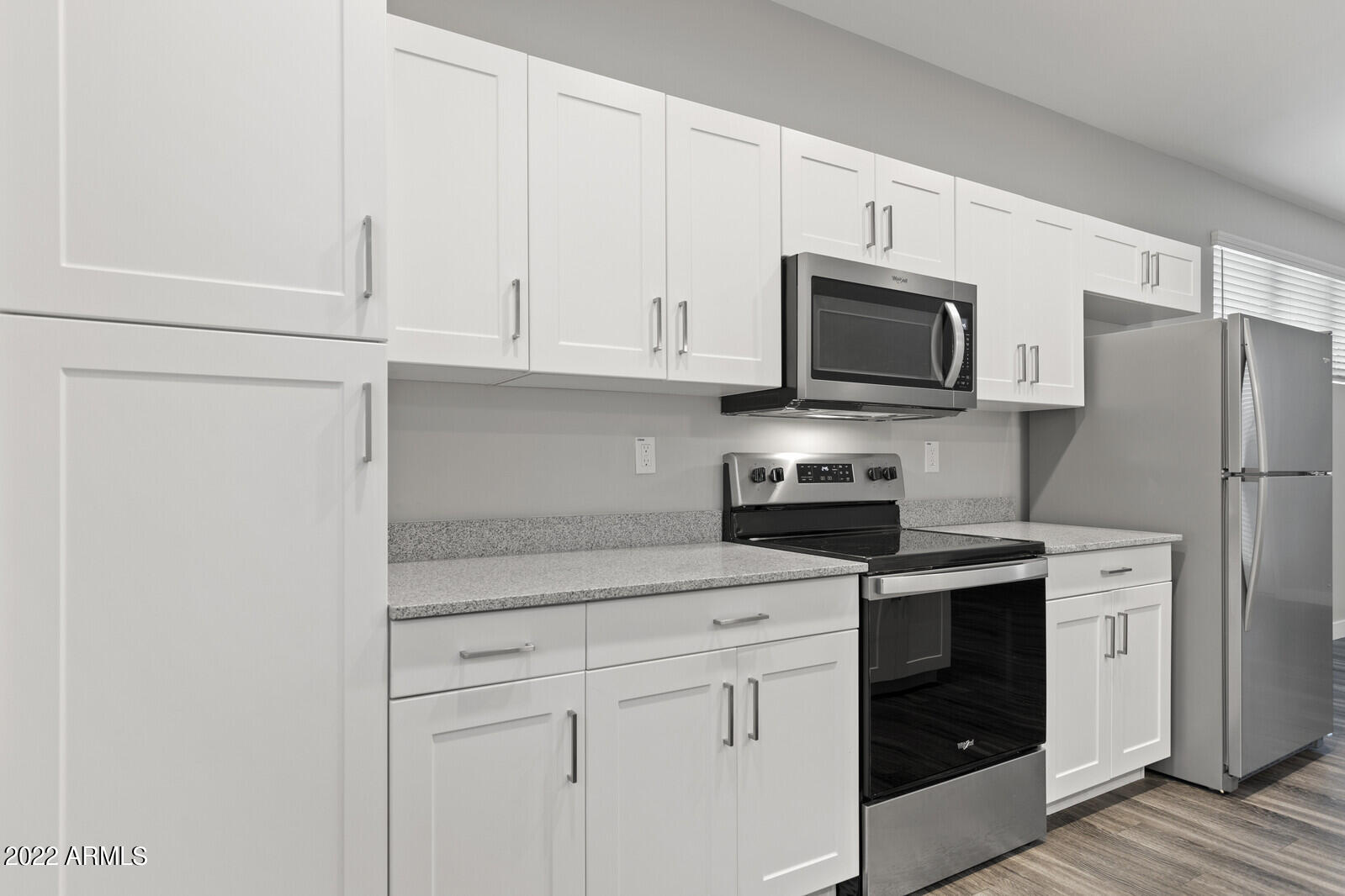 2245 North Dayton Street, Unit 4 Phoenix, AZ 85006 - Photo 8 of 28 a kitchen with stainless steel appliances granite countertop white cabinets sink and a refrigerator